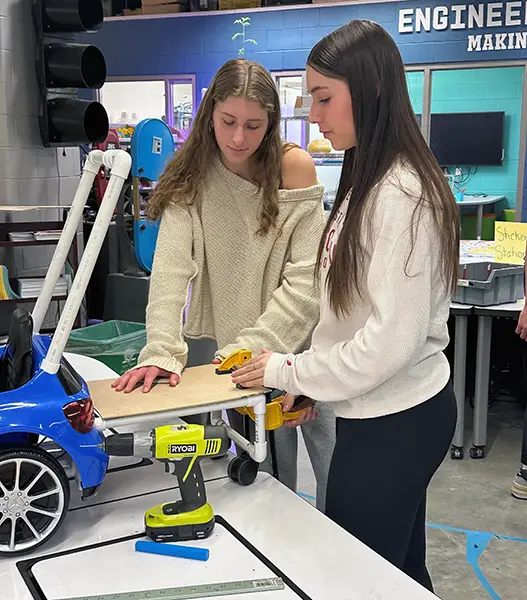 Students fabricating modifications to accommodate children's needs